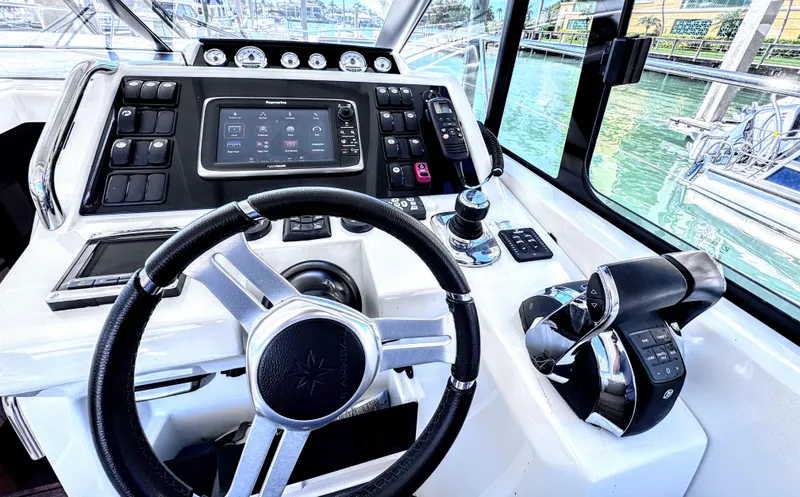 Ganesha Yacht Photos Pics Helm of 2016 Jeanneau 36 Leader boat with modern controls and navigation system.