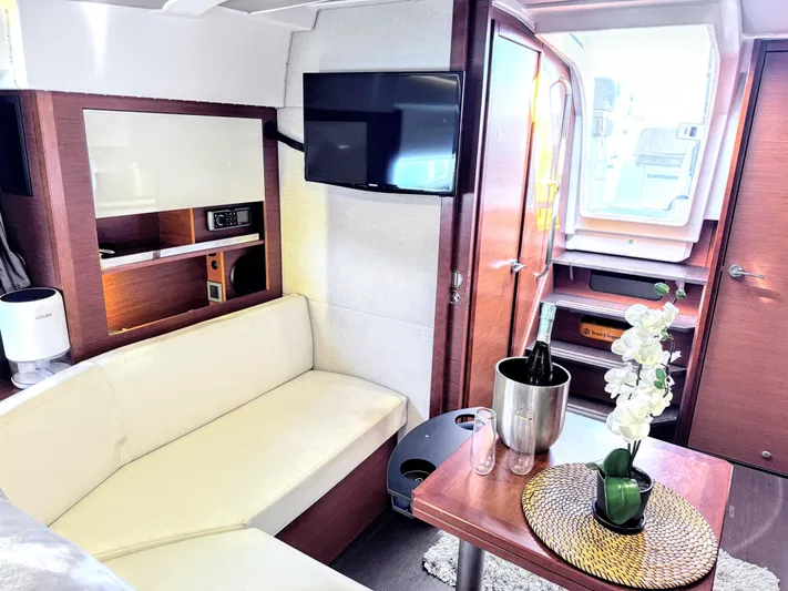 Ganesha Yacht Photos Pics Luxurious interior of 2016 Jeanneau 36 Leader yacht with cozy seating and elegant decor.