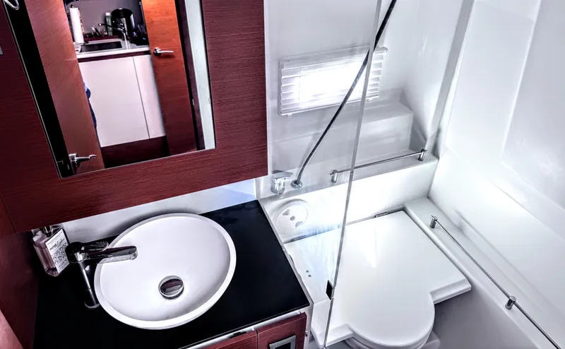 Ganesha Yacht Photos Pics Modern bathroom interior on a 2016 Jeanneau 36 Leader yacht, featuring a sleek sink and shower.