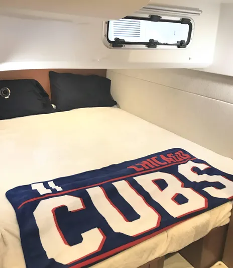 Ganesha Yacht Photos Pics Cozy cabin interior of 2016 Jeanneau 36 Leader with Chicago Cubs blanket on bed.
