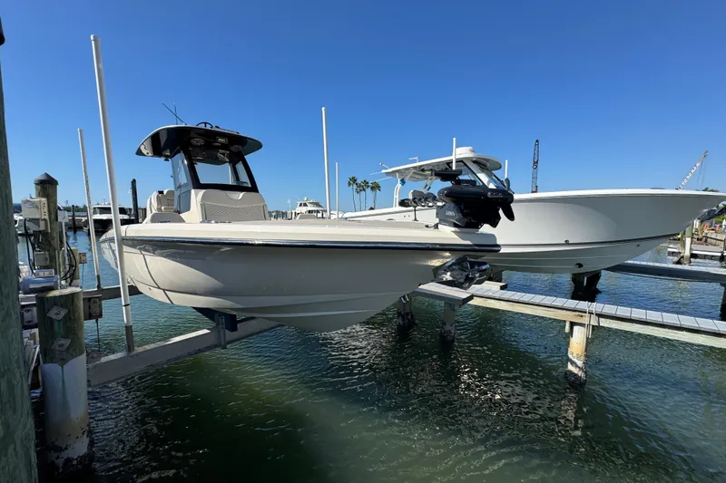  Yacht Photos Pics 2025 Scout 281 XSS boat docked at marina under clear blue sky.