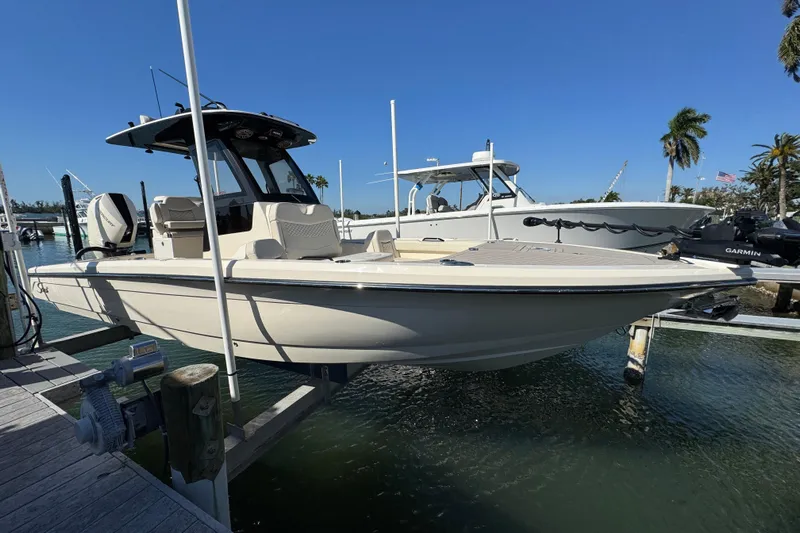  Yacht Photos Pics 2025 Scout 281 XSS boat docked in a marina under clear blue skies.