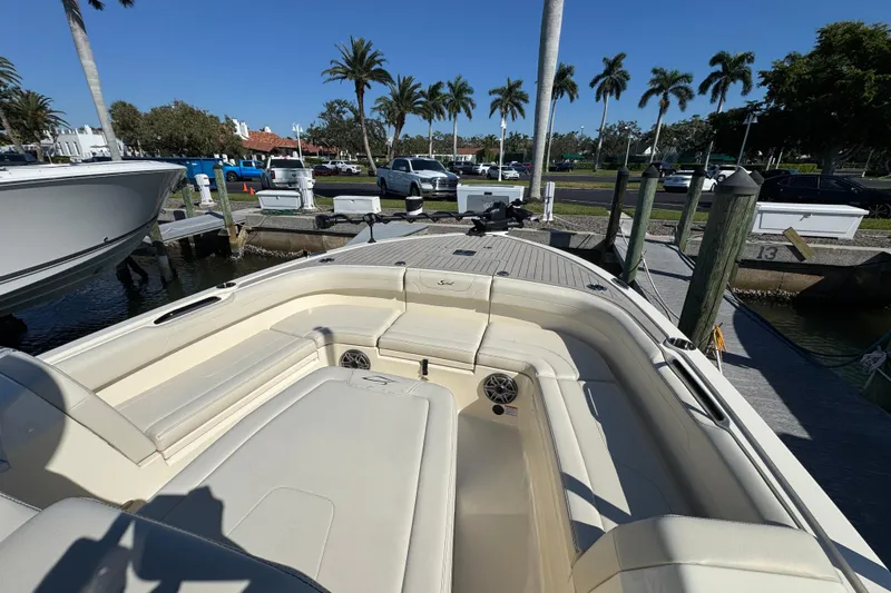  Yacht Photos Pics 2025 Scout 281 XSS boat docked, featuring spacious seating and sleek design.