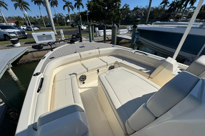  Yacht Photos Pics 2025 Scout 281 XSS boat interior with plush seating and modern design at a marina.