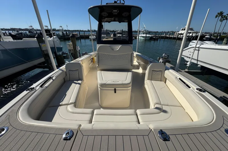  Yacht Photos Pics 2025 Scout 281 XSS boat interior with spacious seating at marina dock.