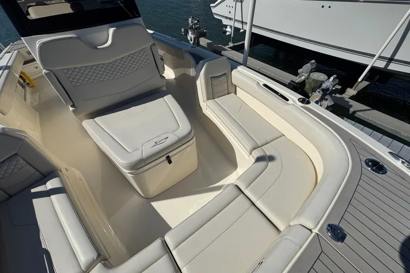  Yacht Photos Pics Luxurious seating area on 2025 Scout 281 XSS boat, docked by the water.