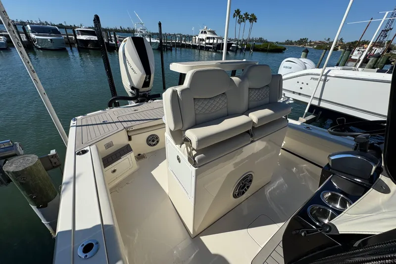  Yacht Photos Pics 2025 Scout 281 XSS boat interior with luxurious seating and modern design at a marina.