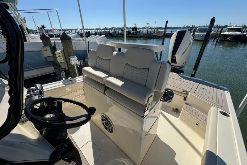  Yacht Photos Pics 2025 Scout 281 XSS boat interior with helm, seating, and water view.