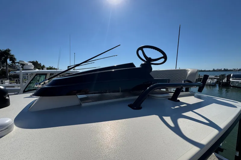  Yacht Photos Pics 2025 Scout 281 XSS boat helm with steering wheel under clear blue sky.