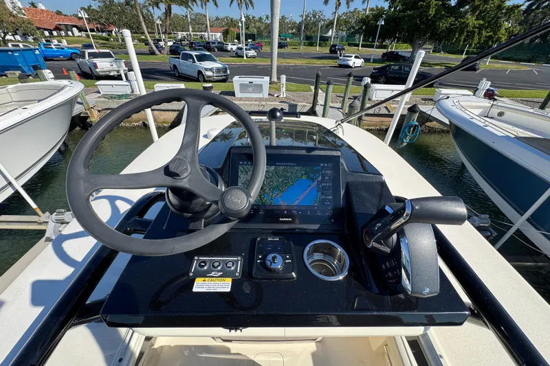  Yacht Photos Pics 2025 Scout 281 XSS boat helm with steering wheel and navigation display.