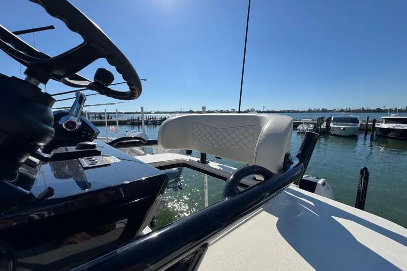  Yacht Photos Pics 2025 Scout 281 XSS boat helm with luxurious seating, docked at marina.