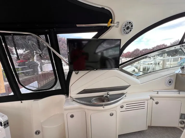 Cayetana Yacht Photos Pics 2004 Sea Ray 390 Sundancer interior with TV, sink, and cabinets.