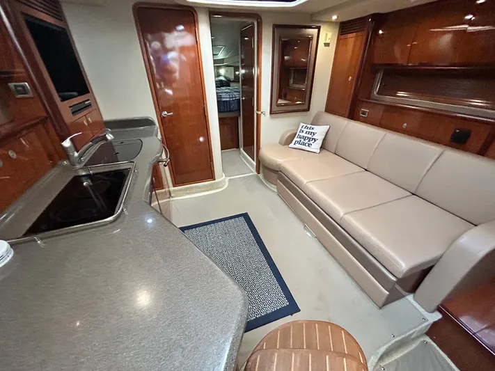 Cayetana Yacht Photos Pics 2004 Sea Ray 390 Sundancer interior with kitchen, sofa, and cozy cabin space.