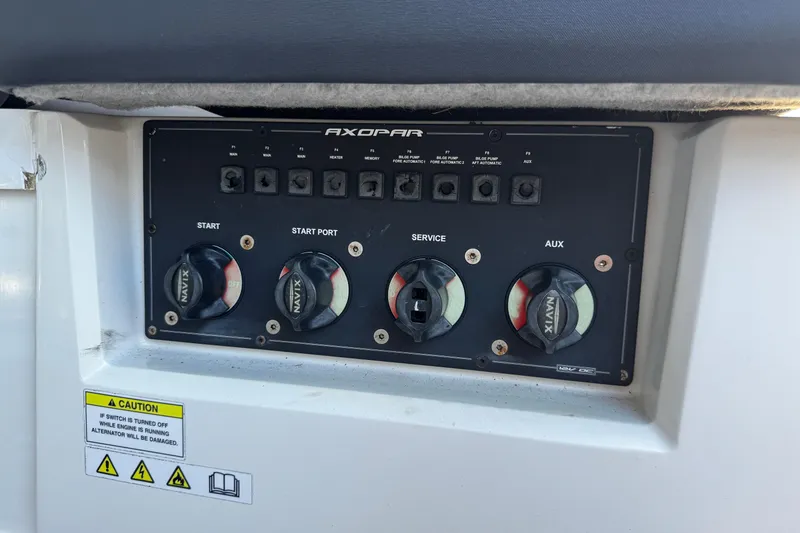  Yacht Photos Pics Control panel of a 2017 Axopar 37 Sun Top boat with switches and caution label.
