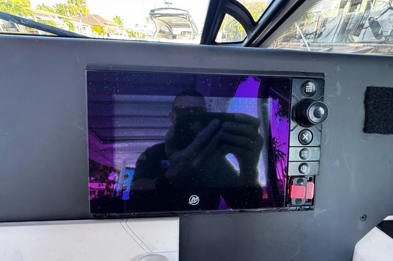  Yacht Photos Pics Control panel of a 2017 Axopar 37 Sun Top boat with reflection on the screen.