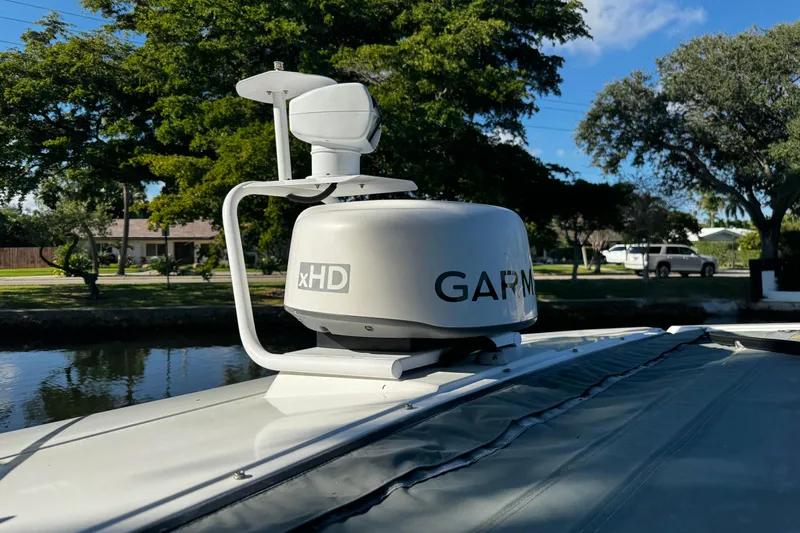  Yacht Photos Pics Garmin xHD radar on 2017 Axopar 37 Sun Top boat, docked near trees.