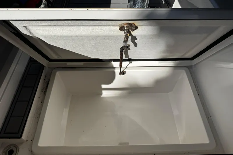  Yacht Photos Pics Open storage compartment on a 2017 Axopar 37 Sun Top boat, showing interior details.
