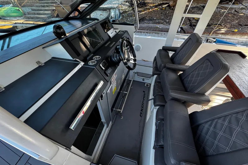  Yacht Photos Pics 2017 Axopar 37 Sun Top boat interior with modern dashboard and comfortable seating.