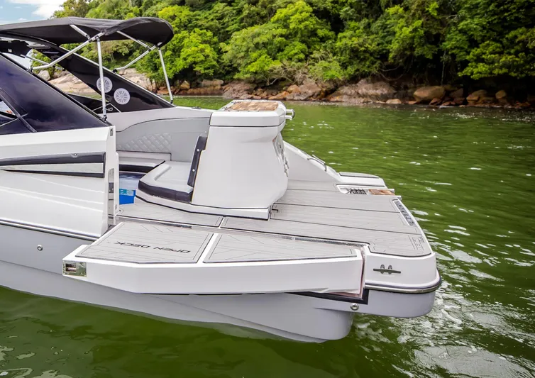  Yacht Photos Pics 2025 NHD 255 Open Deck boat with swim platform on a lake.