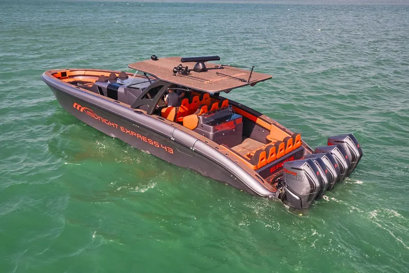  Yacht Photos Pics 2024 Midnight Express 43' Solstice boat with orange seating and multiple outboard engines on the water.