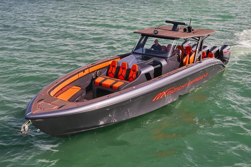  Yacht Photos Pics 2024 Midnight Express 43' Solstice boat cruising on clear green water.