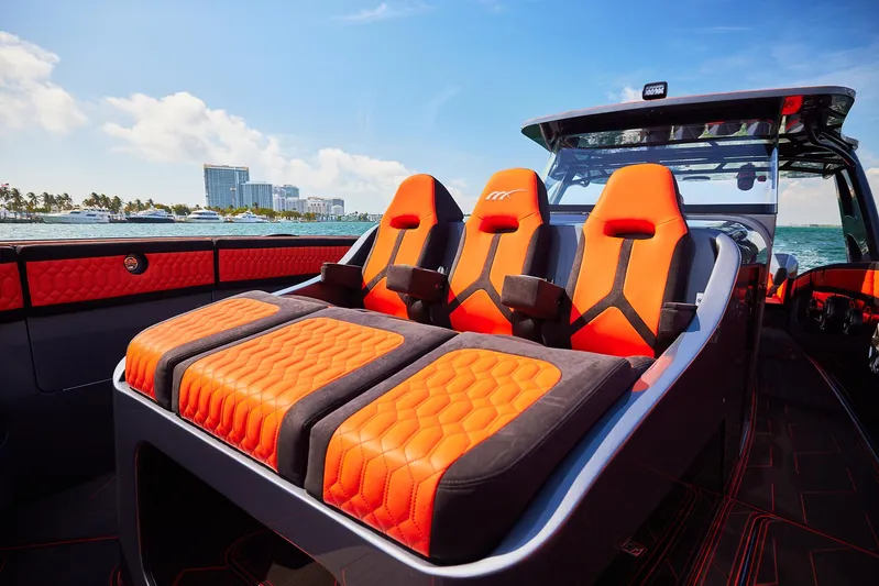  Yacht Photos Pics 2024 Midnight Express 43' Solstice boat with vibrant orange seating on open water.