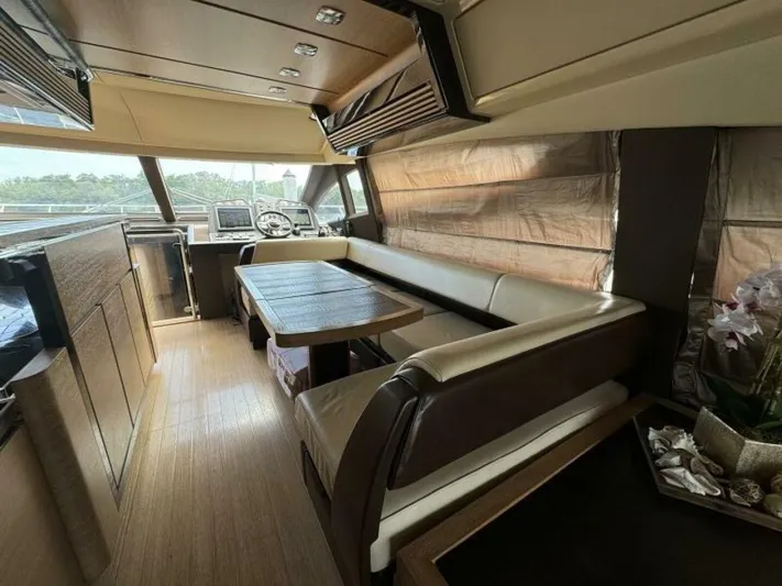 Odyssey Yacht Photos Pics Luxurious interior of 2013 Azimut 64 Fly yacht with dining area and helm station.
