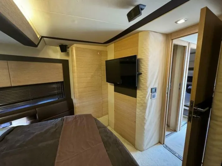 Odyssey Yacht Photos Pics Interior of 2013 Azimut 64 Fly yacht bedroom with TV and modern decor.