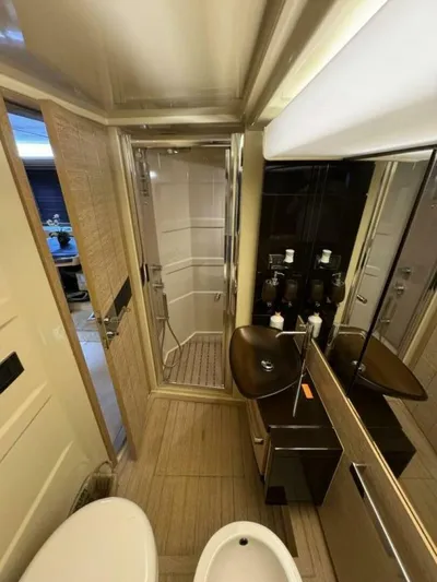 Odyssey Yacht Photos Pics Luxurious bathroom in a 2013 Azimut 64 Fly yacht with modern fixtures and shower.