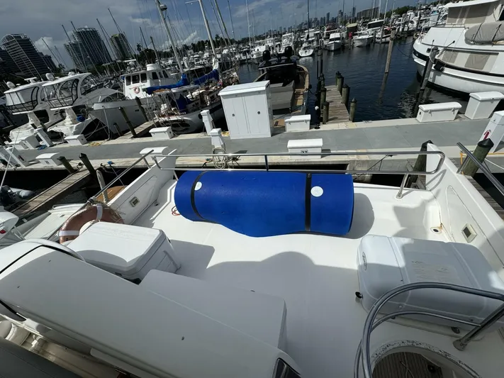 Odyssey Yacht Photos Pics 2013 Azimut 64 Fly yacht docked at a marina with blue barrel on deck.