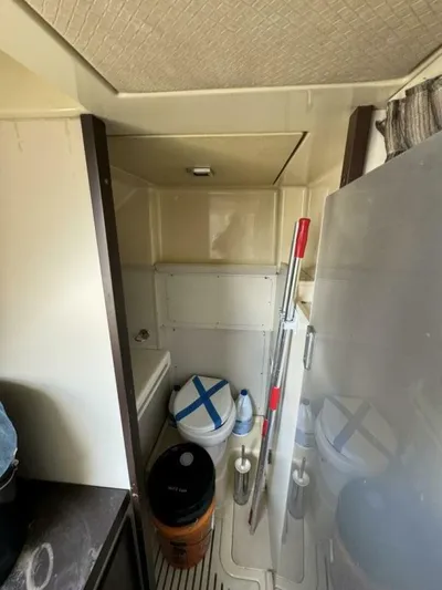 Odyssey Yacht Photos Pics Storage area on a 2013 Azimut 64 Fly yacht with cleaning supplies.