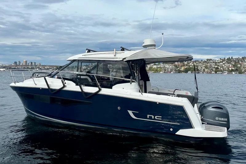  Yacht Photos Pics 2018 Jeanneau NC 895 boat on water with cityscape background.