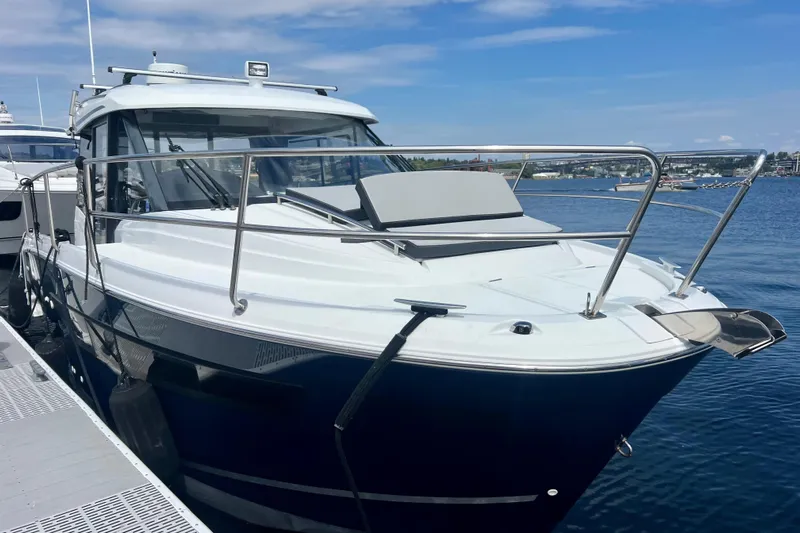  Yacht Photos Pics 2018 Jeanneau NC 895 boat docked on a sunny day, showcasing sleek design.