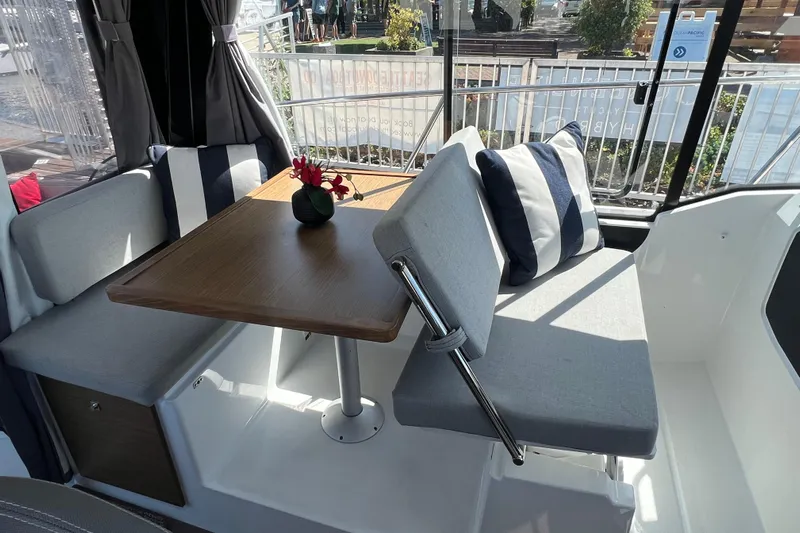  Yacht Photos Pics Interior of 2018 Jeanneau NC 895 boat with cozy seating and table.