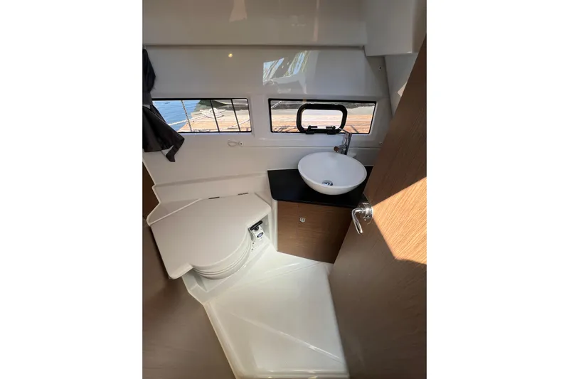  Yacht Photos Pics Compact bathroom in 2018 Jeanneau NC 895 boat with sink and toilet.