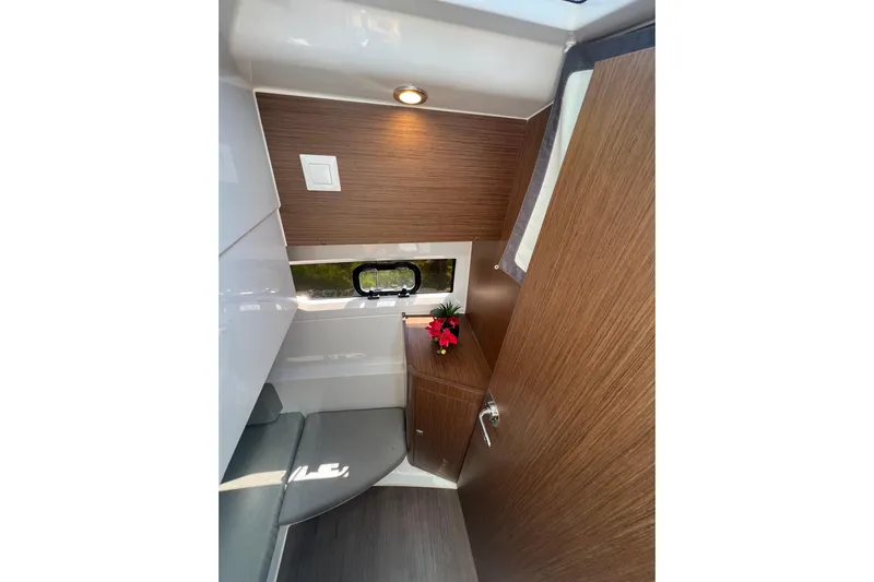  Yacht Photos Pics Interior of 2018 Jeanneau NC 895 boat with wood paneling and seating area.