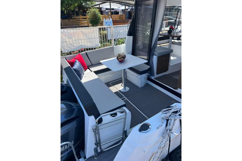  Yacht Photos Pics 2018 Jeanneau NC 895 boat deck with seating, table, and outdoor decor.