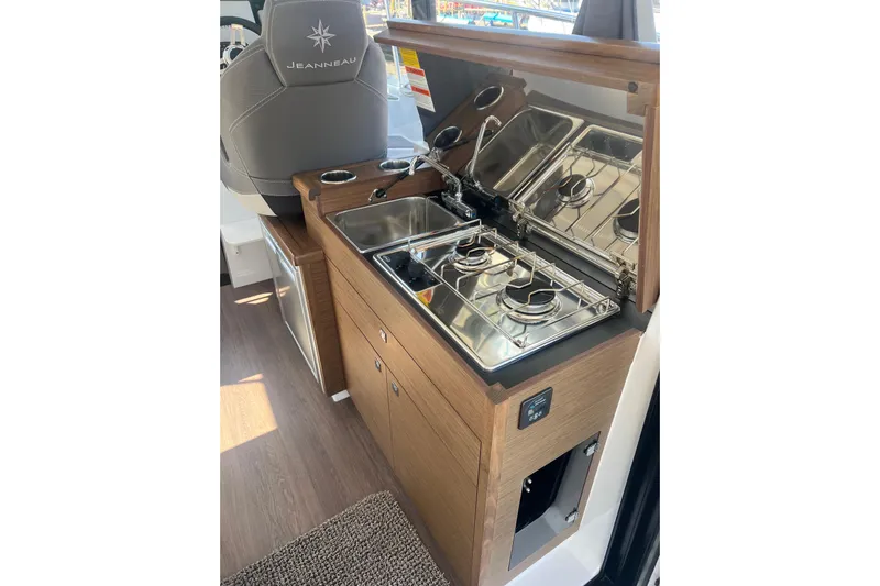  Yacht Photos Pics Compact kitchen area in 2018 Jeanneau NC 895 boat with stove and sink.