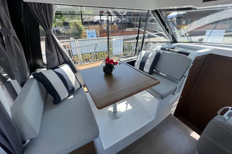  Yacht Photos Pics Interior of 2018 Jeanneau NC 895 boat with cozy seating and table.