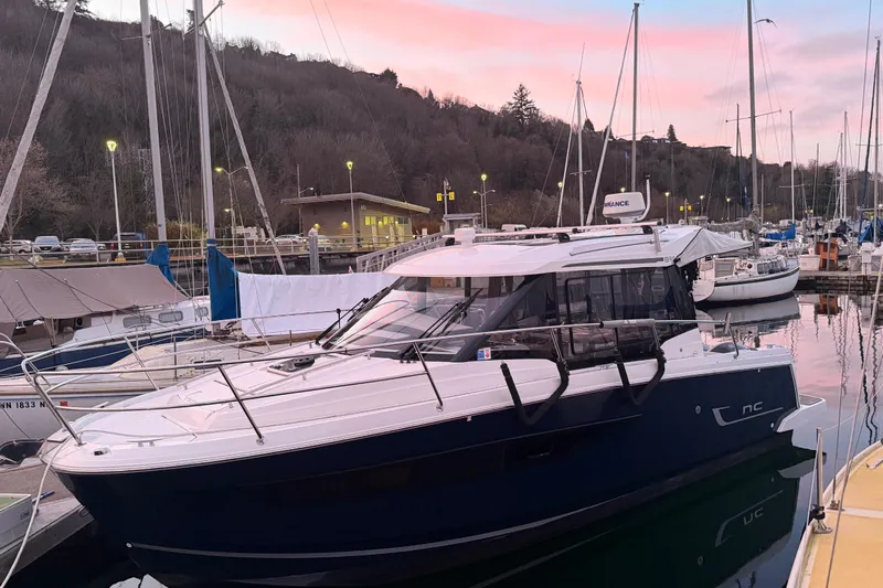  Yacht Photos Pics 2018 Jeanneau NC 895 boat docked at marina during sunset.