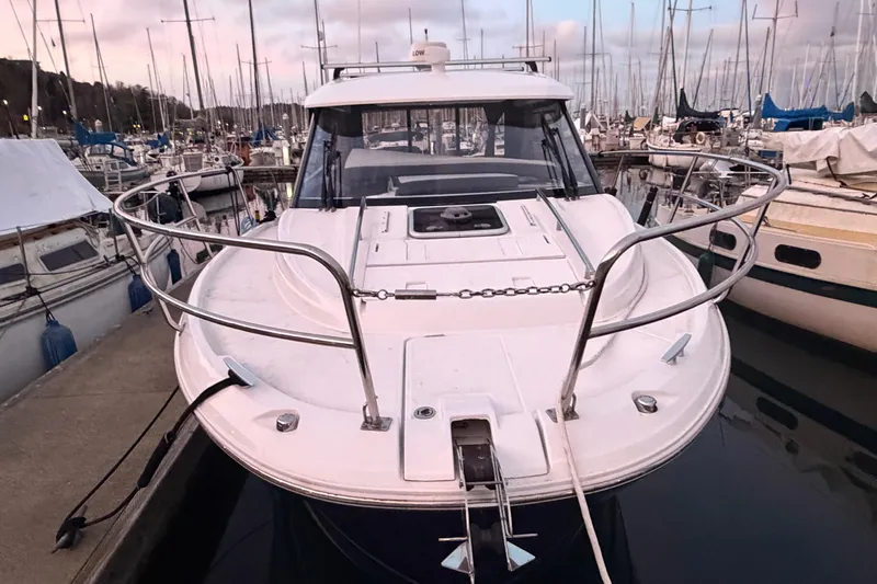  Yacht Photos Pics 2018 Jeanneau NC 895 boat docked at marina, surrounded by sailboats.