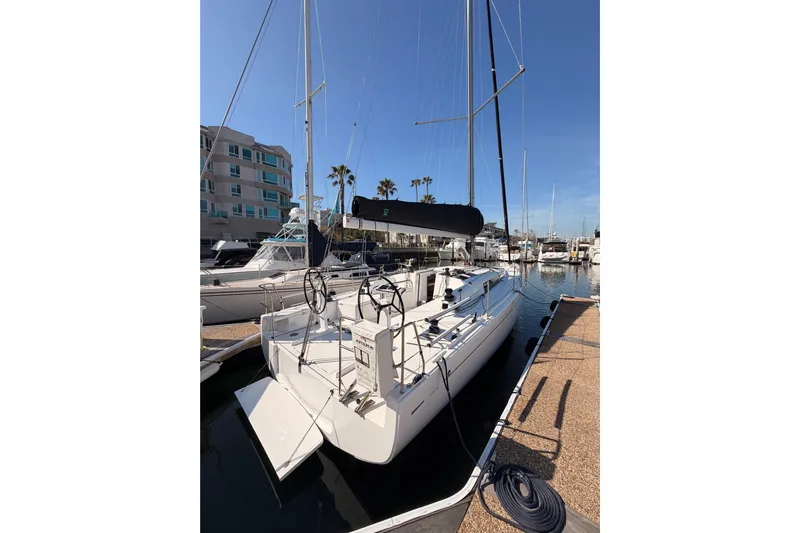 First 36 Yacht Photos Pics 2023 Beneteau First 36 sailboat docked at marina under clear blue sky.