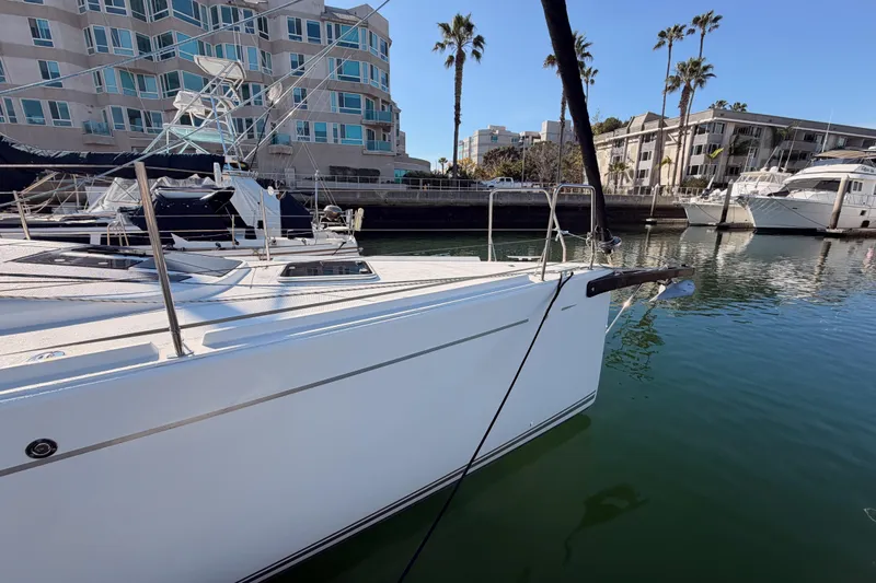 First 36 Yacht Photos Pics 2023 Beneteau First 36 yacht docked in a marina with modern buildings.