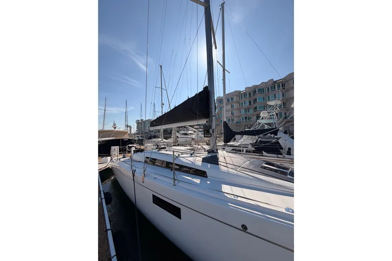 First 36 Yacht Photos Pics 2023 Beneteau First 36 sailboat docked at marina under clear blue sky.