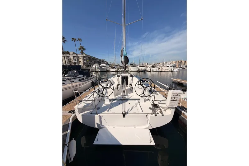 First 36 Yacht Photos Pics 2023 Beneteau First 36 sailboat docked in a marina under clear blue skies.