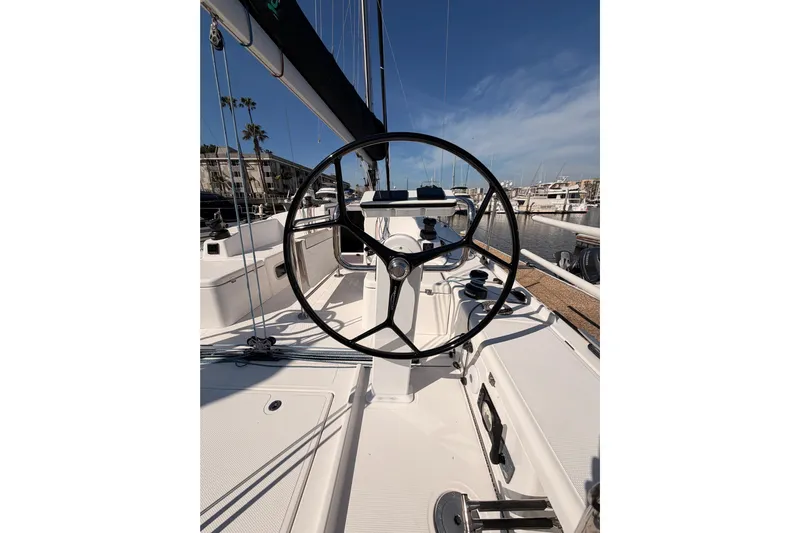 First 36 Yacht Photos Pics 2023 Beneteau First 36 sailboat cockpit with steering wheel, docked in marina.
