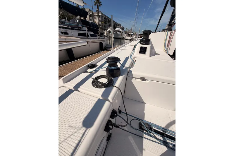 First 36 Yacht Photos Pics 2023 Beneteau First 36 sailboat deck with winches and ropes in marina setting.