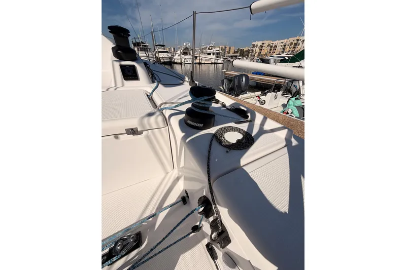 First 36 Yacht Photos Pics 2023 Beneteau First 36 sailboat deck with winches and ropes in marina.
