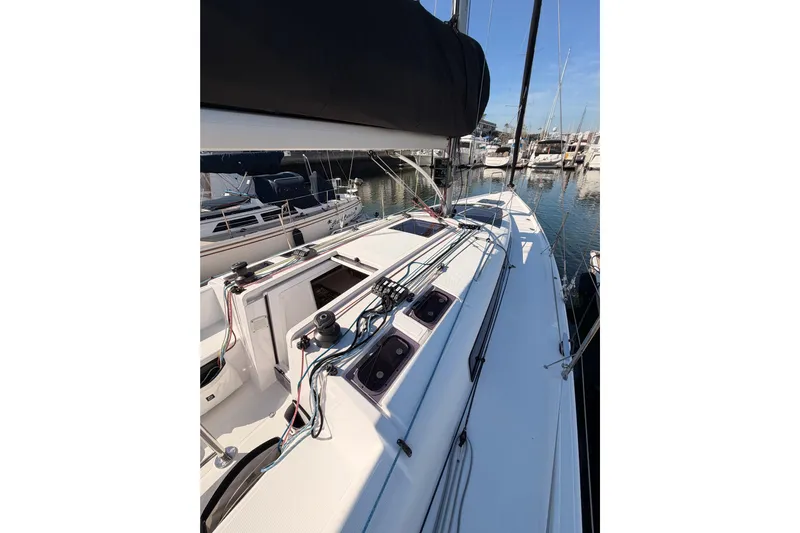First 36 Yacht Photos Pics 2023 Beneteau First 36 sailboat deck view in marina, showcasing sleek design and rigging.