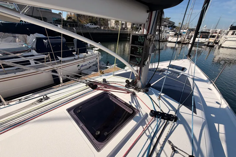 First 36 Yacht Photos Pics 2023 Beneteau First 36 sailboat deck with rigging and digital displays in a marina.